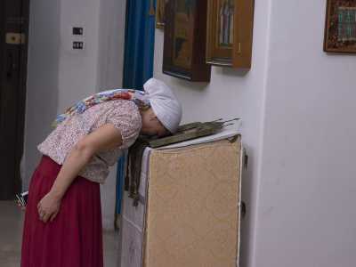 LA donna poggia la fronte sull'icona di San Nicola per qualche minuto: un modo per ringraziare di un favore ricevuto